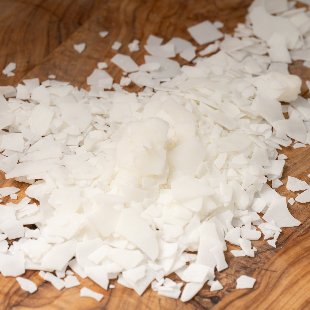 Candle wax flakes on a wooden surface