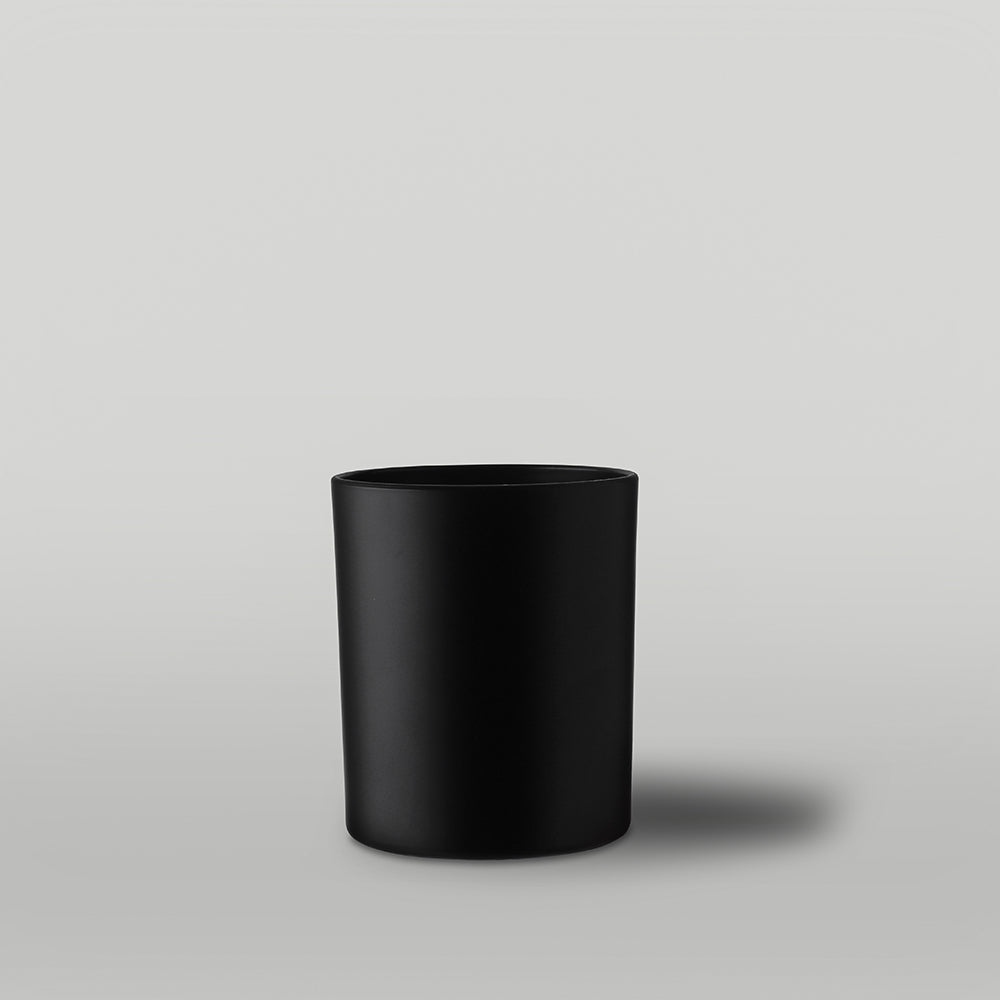 Black candle container on a gray background