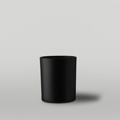 Black candle container on a gray background