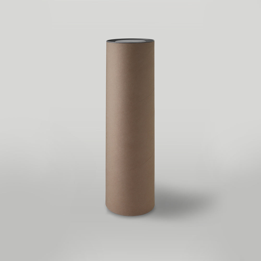 Cylindrical brown candle packaging on a light grey background
