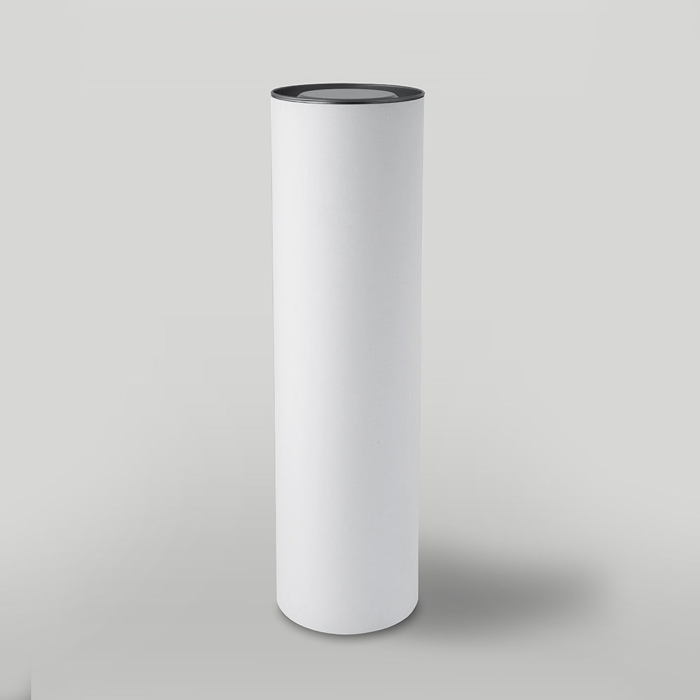 Cylindrical white candle packaging with black top on a light grey background