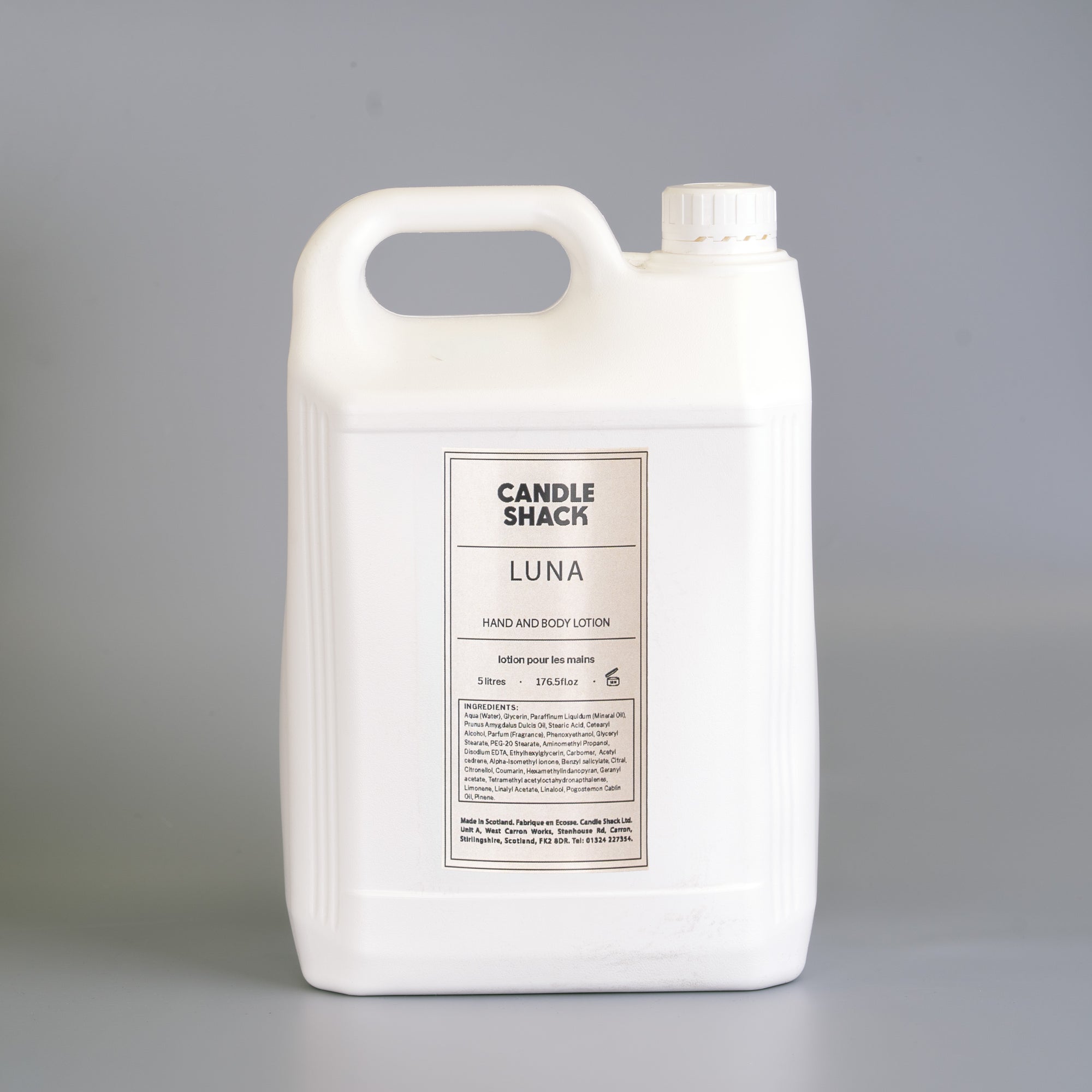 Large white container of 'Luna' hand and body lotion from Candle Shack on a gray background