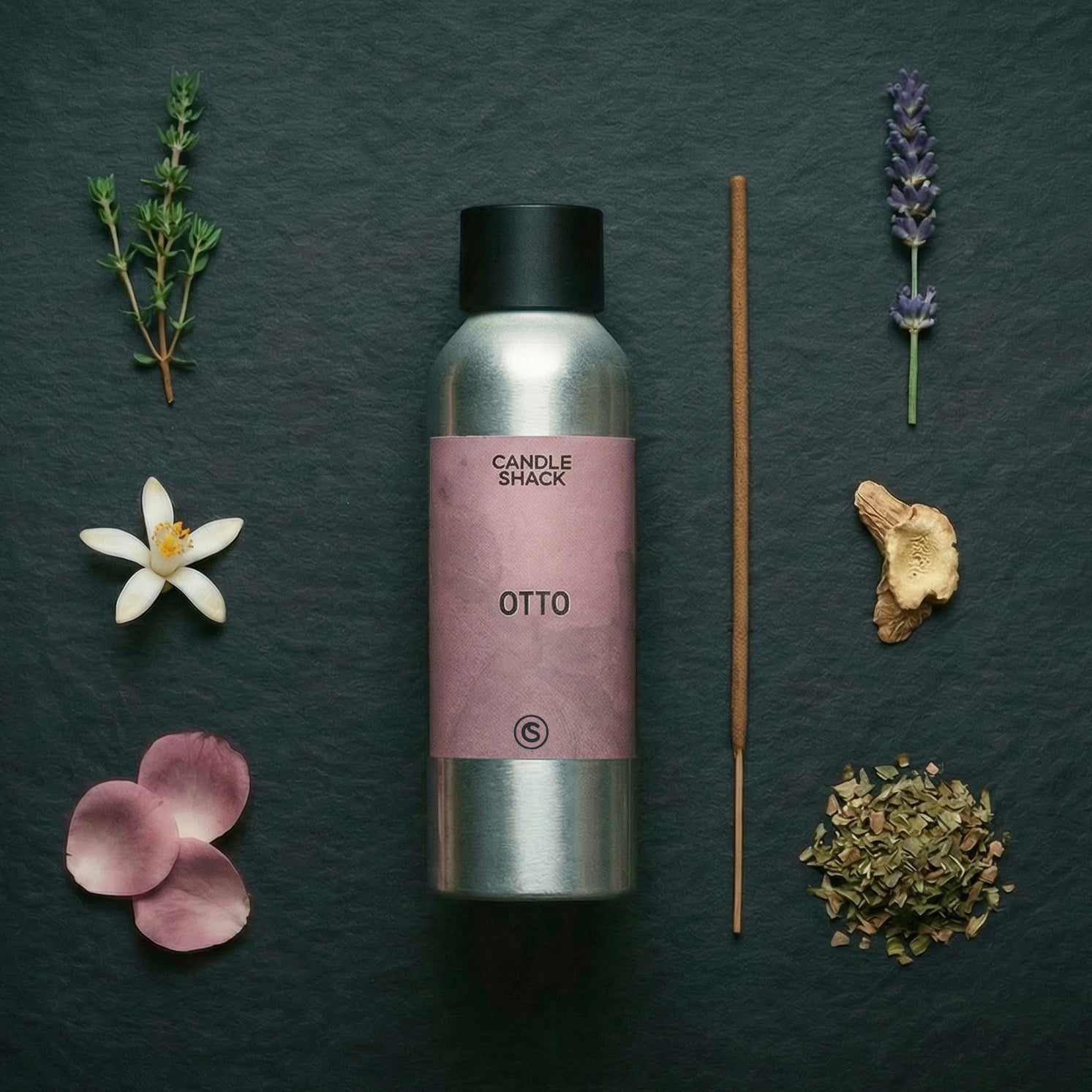 Candle Shack Otto diffuser bottle with lavender, thyme, and other botanicals on a dark surface