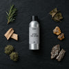 After The Storm fragrance oil - Candle Shack aluminium bottle with dried botanicals on a dark slate background