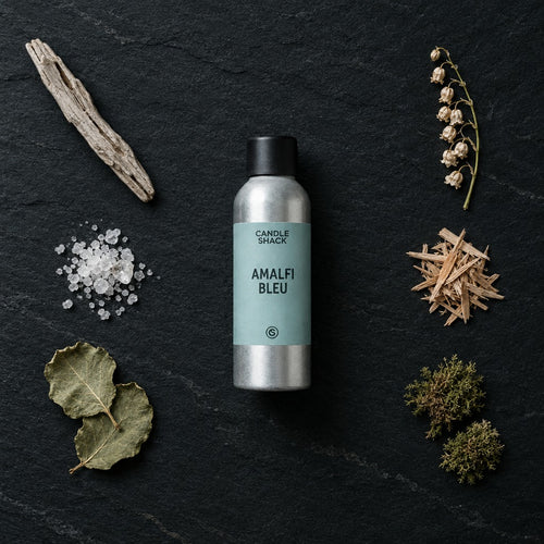 Amalfi Bleu fragrance oil - Candle Shack aluminium bottle with dried botanicals on a dark slate background