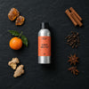 Amber Nectar fragrance oil - Candle Shack aluminium bottle with dried botanicals on a dark slate background