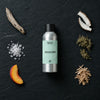 AquaLume fragrance oil - Candle Shack aluminium bottle with dried botanicals on a dark slate background