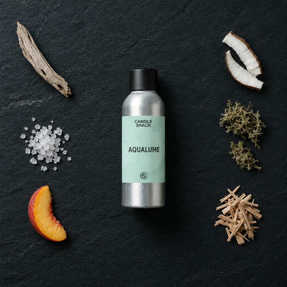 AquaLume fragrance oil - Candle Shack aluminium bottle with dried botanicals on a dark slate background