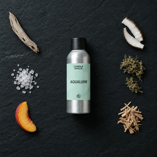 AquaLume fragrance oil - Candle Shack aluminium bottle with dried botanicals on a dark slate background