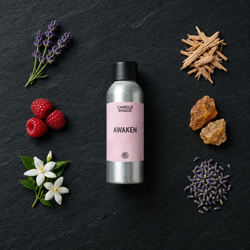 Awaken fragrance oil - Candle Shack aluminium bottle with dried botanicals on a dark slate background