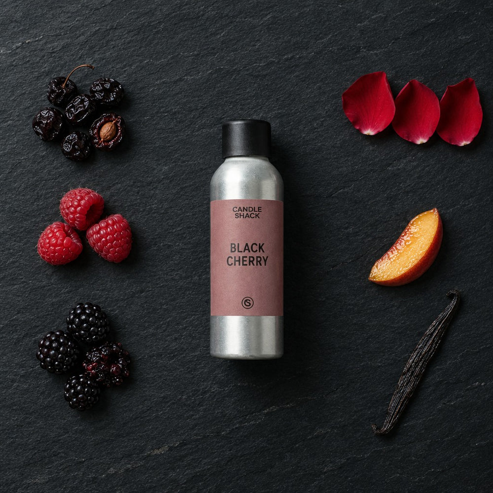 Black Cherry fragrance oil - Candle Shack aluminium bottle with dried botanicals on a dark slate background