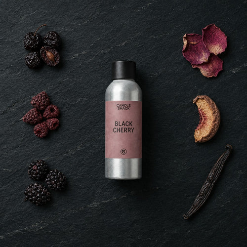 Black Cherry fragrance oil - Candle Shack aluminium bottle with dried botanicals on a dark slate background