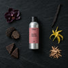 Black Orchid fragrance oil - Candle Shack aluminium bottle with dried botanicals on a dark slate background