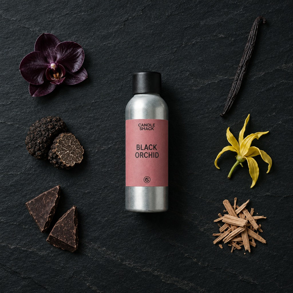 Black Orchid fragrance oil - Candle Shack aluminium bottle with dried botanicals on a dark slate background