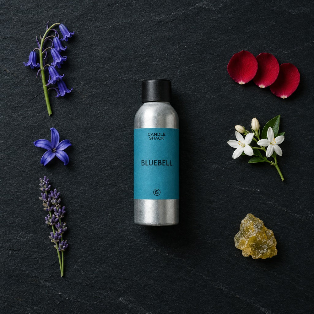 Bluebell fragrance oil - Candle Shack aluminium bottle with dried botanicals on a dark slate background