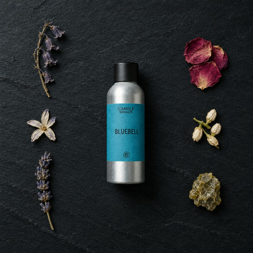 Bluebell fragrance oil - Candle Shack aluminium bottle with dried botanicals on a dark slate background