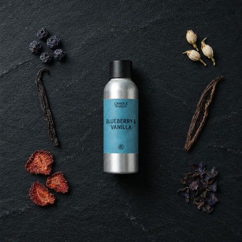 Blueberry & Vanilla fragrance oil - Candle Shack aluminium bottle with dried botanicals on a dark slate background
