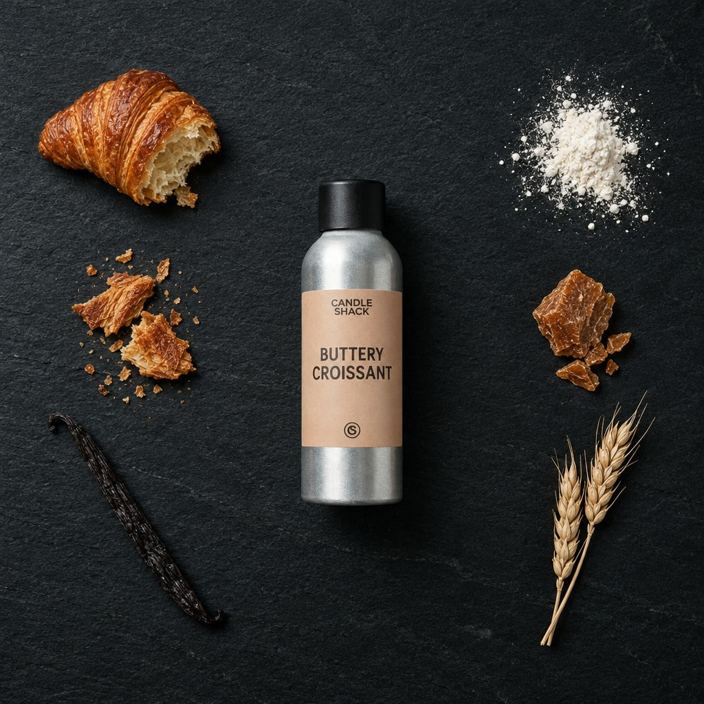 Buttery Croissant fragrance oil - Candle Shack aluminium bottle with dried botanicals on a dark slate background
