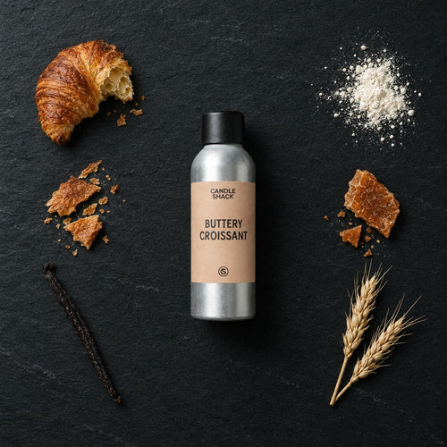 Buttery Croissant fragrance oil - Candle Shack aluminium bottle with dried botanicals on a dark slate background