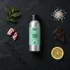 Candy Cane fragrance oil - Candle Shack aluminium bottle with dried botanicals on a dark slate background