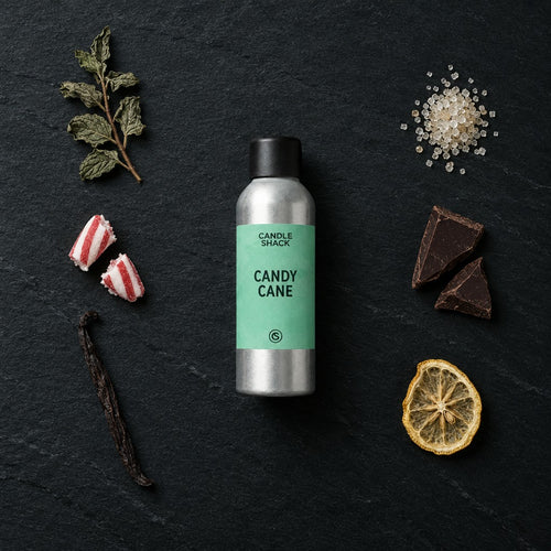 Candy Cane fragrance oil - Candle Shack aluminium bottle with dried botanicals on a dark slate background