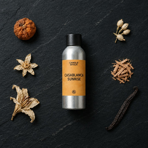 Casablanca Sunrise fragrance oil - Candle Shack aluminium bottle with dried botanicals on a dark slate background