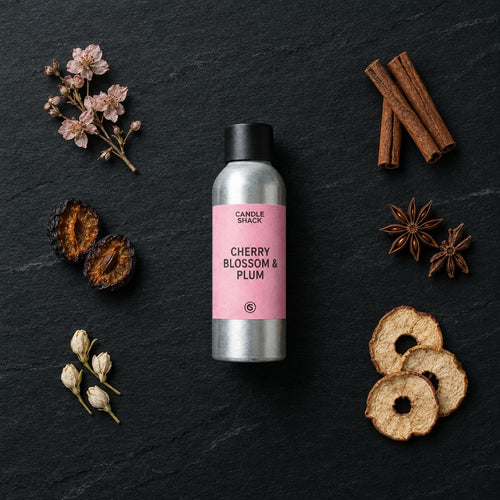 Cherry Blossom & Plum fragrance oil - Candle Shack aluminium bottle with dried botanicals on a dark slate background
