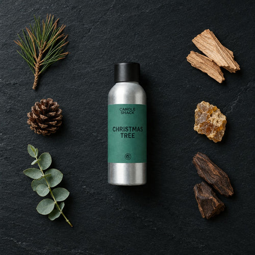 Christmas Tree fragrance oil - Candle Shack aluminium bottle with dried botanicals on a dark slate background