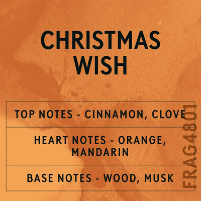 Christmas Wish fragrance oil - Candle Shack aluminium bottle with dried botanicals on a dark slate background