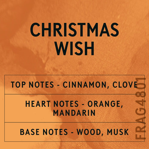 Christmas Wish fragrance oil - Candle Shack aluminium bottle with dried botanicals on a dark slate background