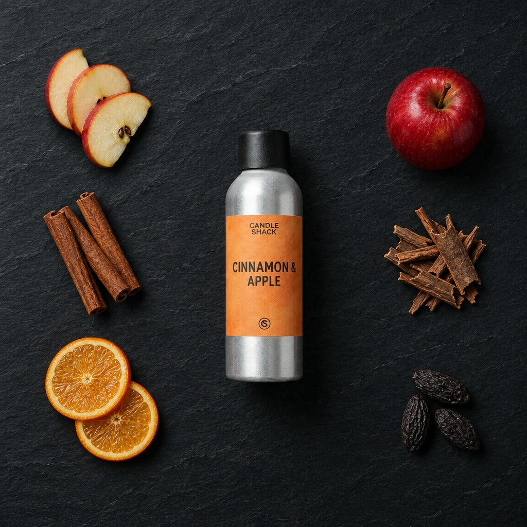 Cinnamon and Apple fragrance oil - Candle Shack aluminium bottle with dried botanicals on a dark slate background