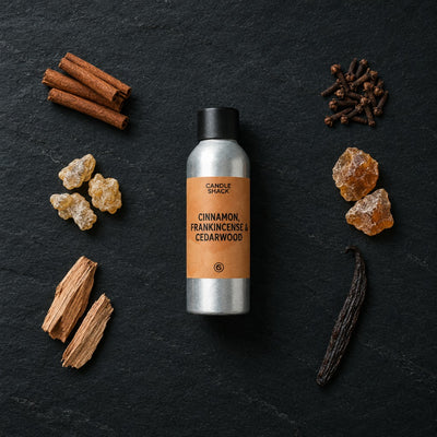 Cinnamon, Frankincense & Cedarwood fragrance oil - Candle Shack aluminium bottle with dried botanicals on a dark slate background