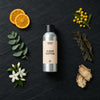 Clean Cotton fragrance oil - Candle Shack aluminium bottle with dried botanicals on a dark slate background