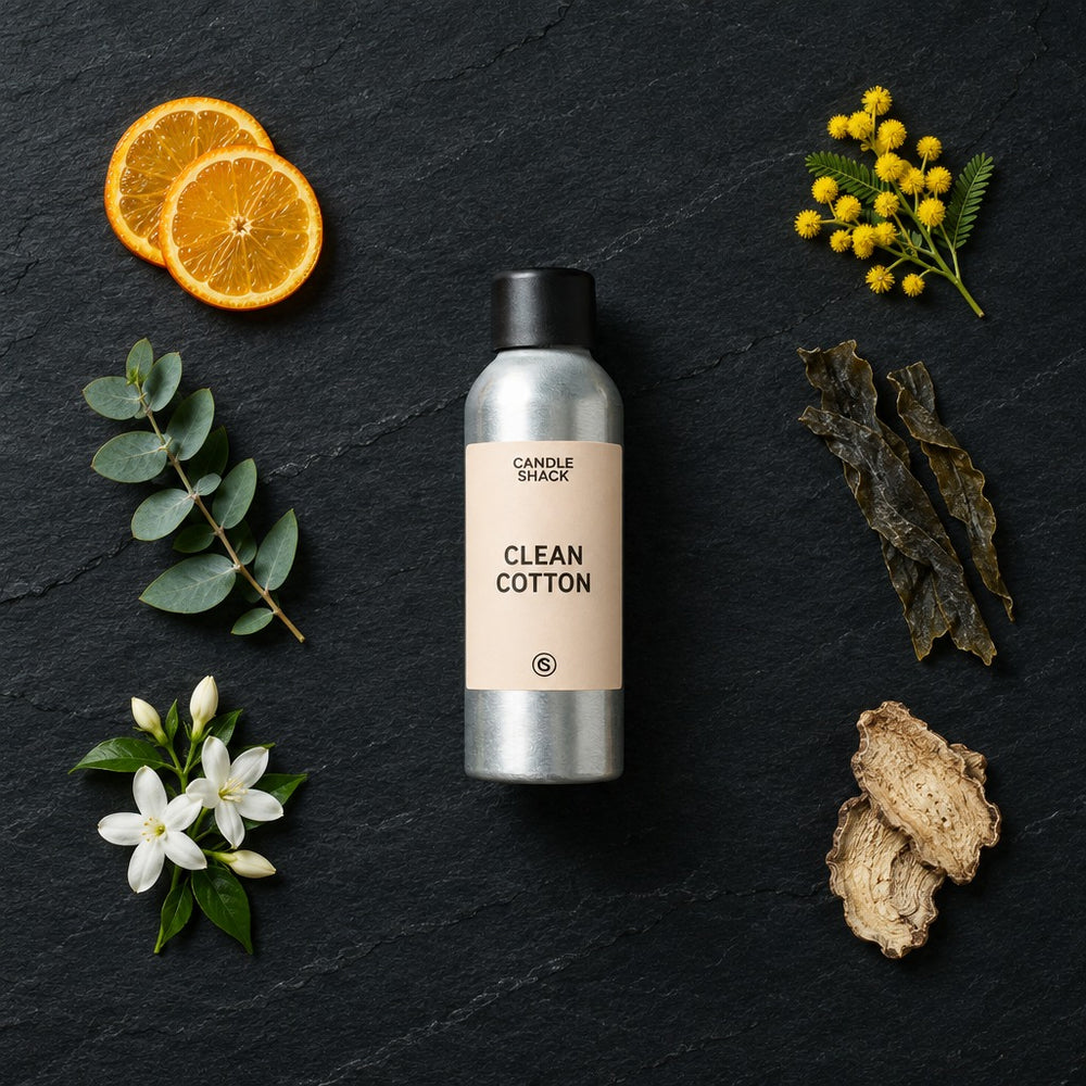 Clean Cotton fragrance oil - Candle Shack aluminium bottle with dried botanicals on a dark slate background
