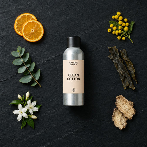 Clean Cotton fragrance oil - Candle Shack aluminium bottle with dried botanicals on a dark slate background