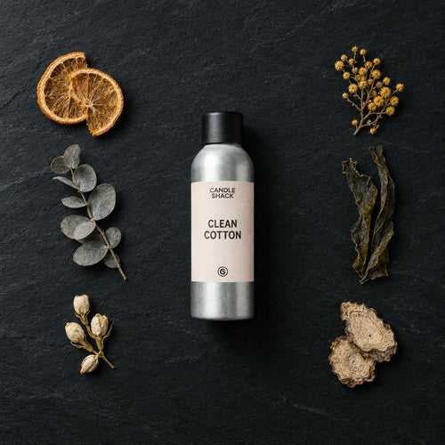 Clean Cotton fragrance oil - Candle Shack aluminium bottle with dried botanicals on a dark slate background