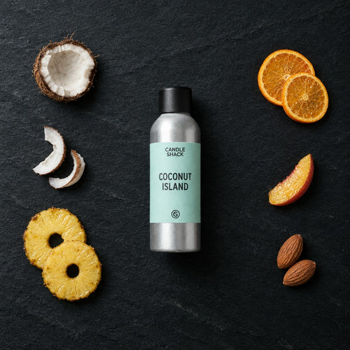 Coconut Island fragrance oil - Candle Shack aluminium bottle with dried botanicals on a dark slate background