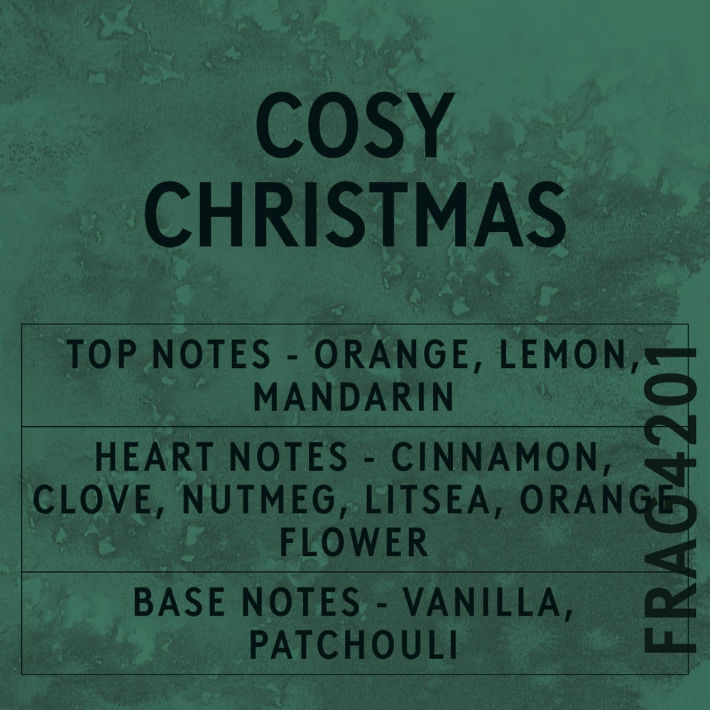 Cosy Christmas fragrance oil - Candle Shack aluminium bottle with dried botanicals on a dark slate background