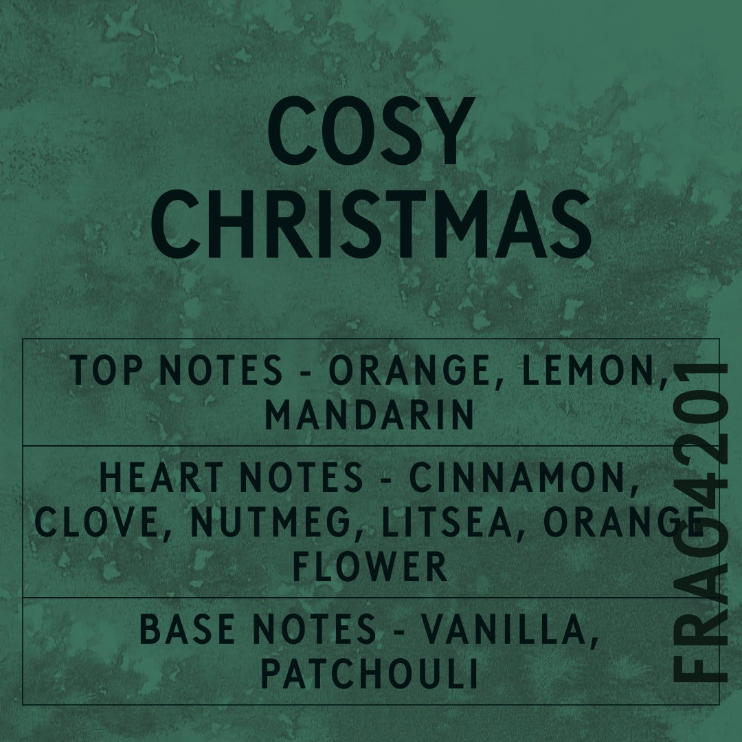 Cosy Christmas fragrance oil - Candle Shack aluminium bottle with dried botanicals on a dark slate background