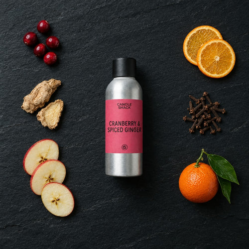 Cranberry & Spiced Ginger fragrance oil - Candle Shack aluminium bottle with dried botanicals on a dark slate background