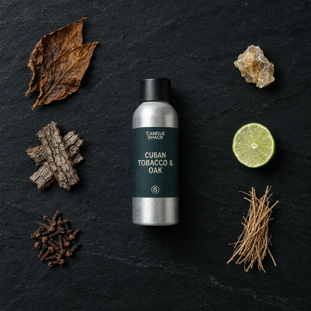 Cuban Tobacco & Oak fragrance oil - Candle Shack aluminium bottle with dried botanicals on a dark slate background