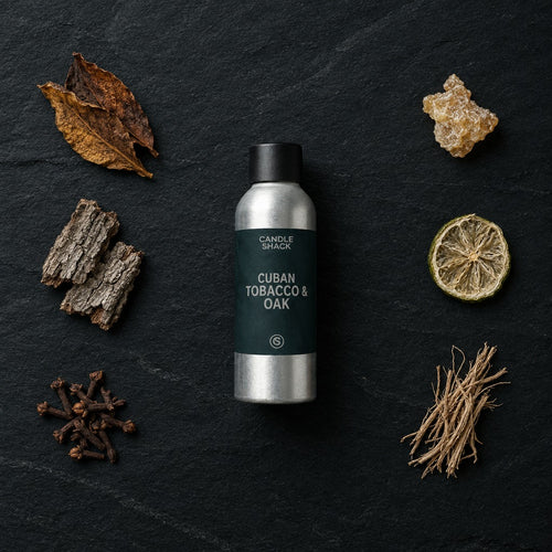 Cuban Tobacco & Oak fragrance oil - Candle Shack aluminium bottle with dried botanicals on a dark slate background
