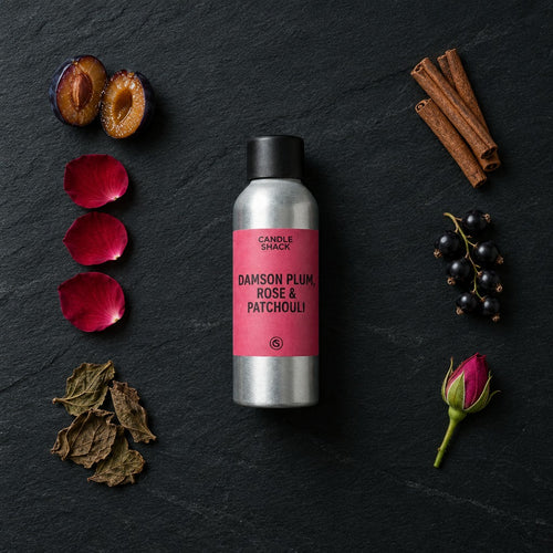 Damson Plum, Rose & Patchouli fragrance oil - Candle Shack aluminium bottle with dried botanicals on a dark slate background