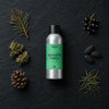 Enchanted Forest fragrance oil - Candle Shack aluminium bottle with dried botanicals on a dark slate background