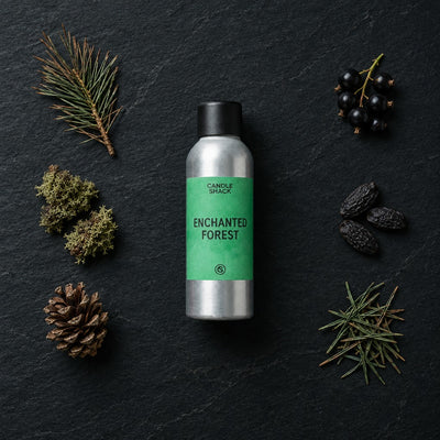 Enchanted Forest fragrance oil - Candle Shack aluminium bottle with dried botanicals on a dark slate background