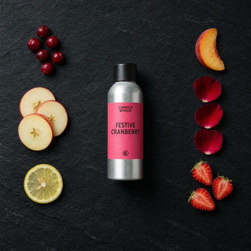 Festive Cranberry fragrance oil - Candle Shack aluminium bottle with dried botanicals on a dark slate background