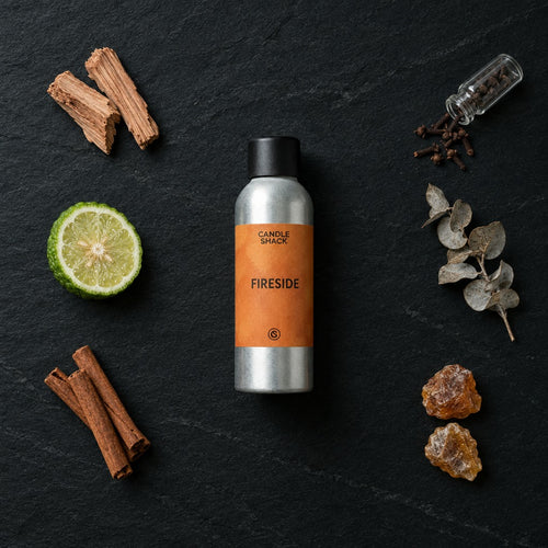 Fireside fragrance oil - Candle Shack aluminium bottle with dried botanicals on a dark slate background