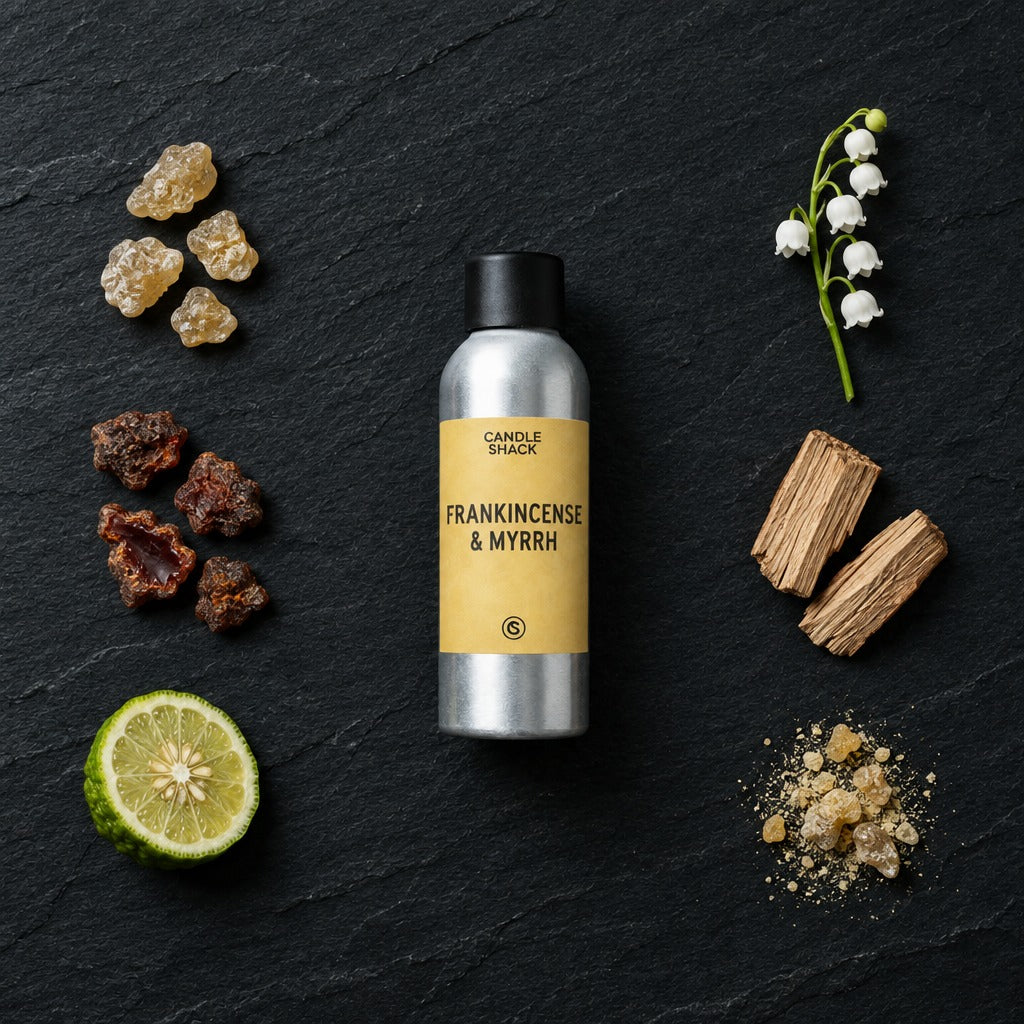 Frankincense & Myrrh fragrance oil - Candle Shack aluminium bottle with dried botanicals on a dark slate background