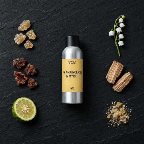Frankincense & Myrrh fragrance oil - Candle Shack aluminium bottle with dried botanicals on a dark slate background