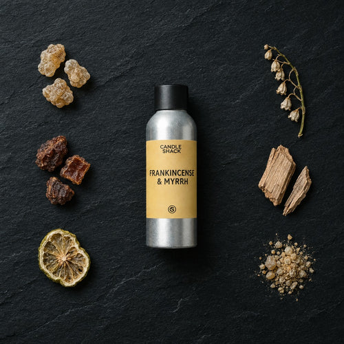 Frankincense & Myrrh fragrance oil - Candle Shack aluminium bottle with dried botanicals on a dark slate background